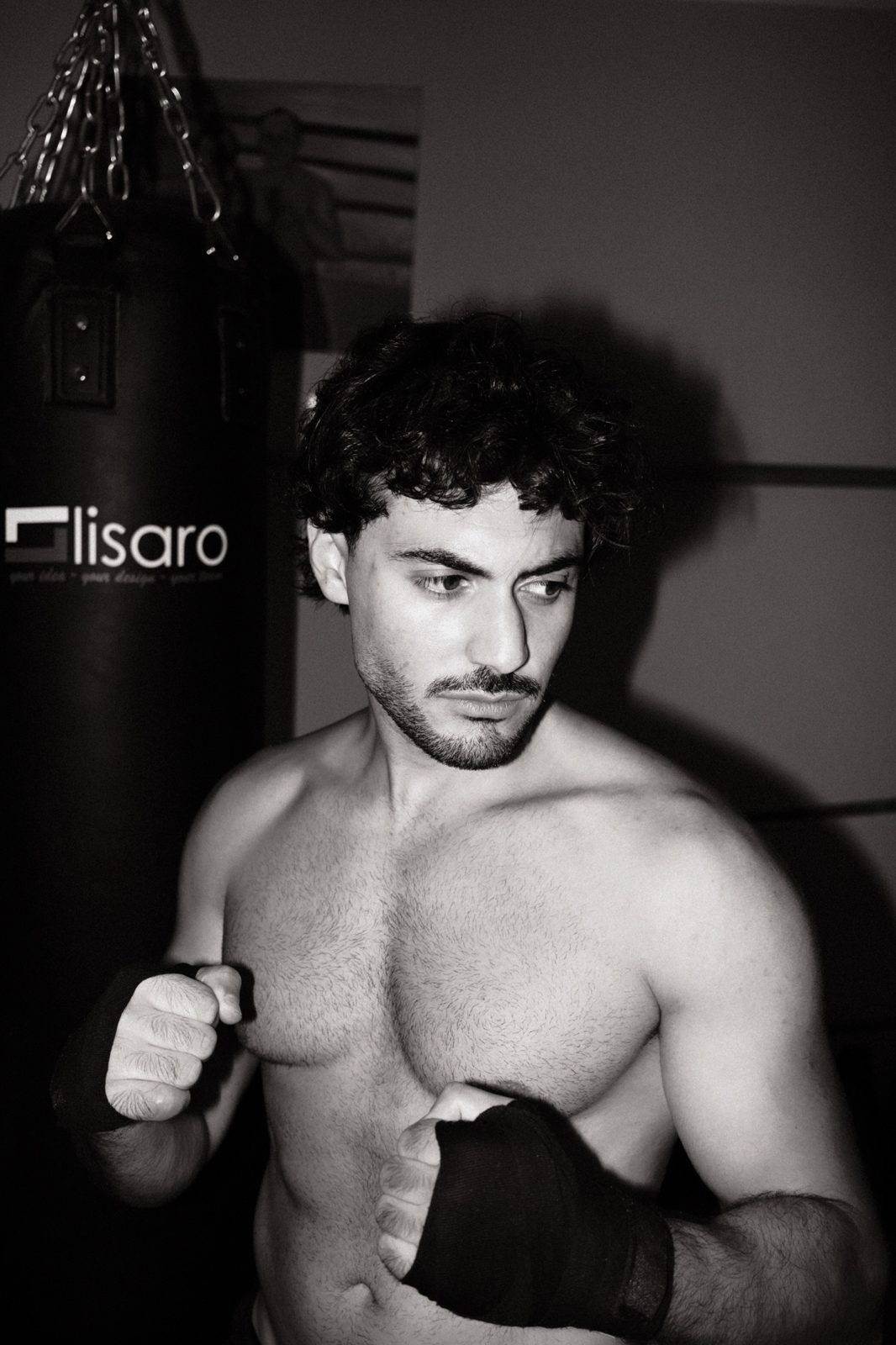 Black and white portrait of a boxer with wrapped hands